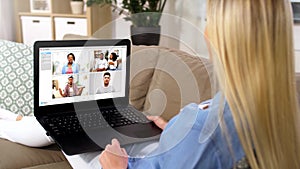 Woman having video chat with her friends on laptop