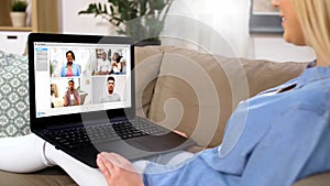 Woman having video chat with her friends on laptop