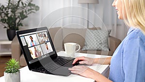 Woman having video chat with her friends on laptop