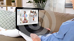 Woman having video chat with her friends on laptop