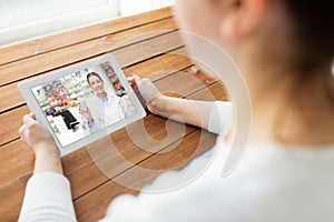 Woman having video chat with pharmacist on tablet