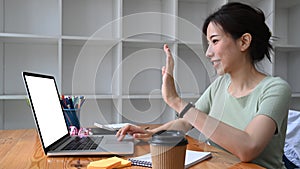 Woman having video conference with her colleagues on laptop computer.