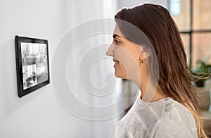 woman having video control from tablet pc at home