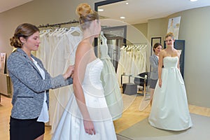 Woman having wedding dress fitting