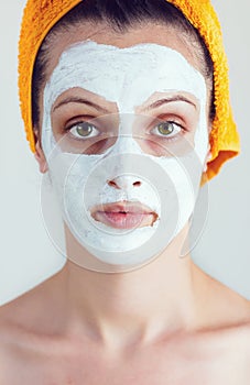 Woman having a white smoothing face mask