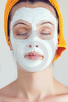 Woman having a white smoothing face mask photo