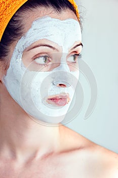 Woman having a white smoothing face mask photo