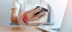 Woman having wrist pain when using mobile phone during working long time on workplace. De Quervain s tenosynovitis, ergonomic,