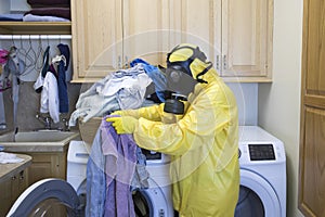 Woman in Haz Mat suit sorting laundry