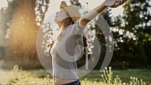 Woman with head back and arms outstretched in nature