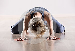 Woman with head down while stretching hip muscles
