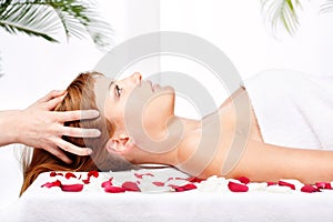 Woman on head massage treatment in salon