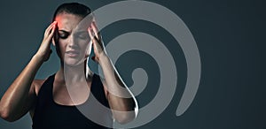 Woman, headache and burnout on exercise in studio on dark background with head pain or inflammation. Female person