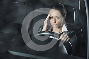 Woman with headache driving