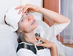 Woman with headache at home