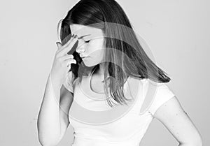 Woman with headache pain. Young woman holding her aching head. black and white