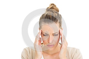 Woman with headache touching her temples