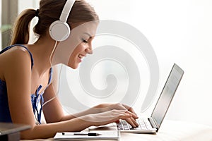 Woman in headphones learning language online