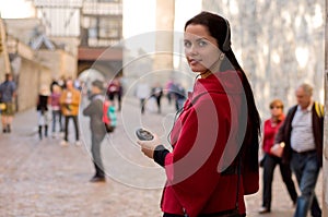 Woman with headphones, listening to audio guide