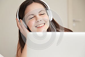 Woman in headphones takes pleasure from music