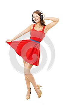 Woman in headpnones dancing listening to music, isolated over white