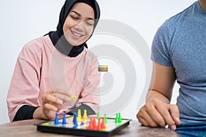 Woman in headscarf playing ludo together