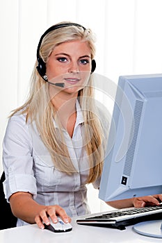 Woman with a headset and computer Hotline at