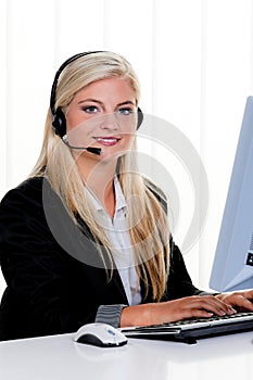 Woman with a headset and computer Hotline at