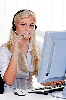 Woman with a headset and computer Hotline at