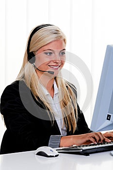 Woman with a headset and computer Hotline