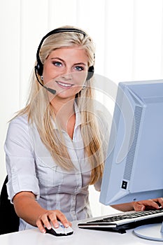 Woman with a headset and computer Hotline