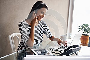 Woman, headset and laptop for call centre hotline, customer support and technical service in office. Female person, crm