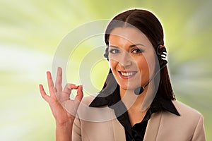 Woman with headset and microphone working in call center for helping customers.