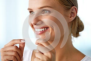 Woman With Healthy White Teeth Using Teeth Whitening Strip