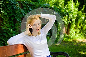 Woman heard bad news. Bad news. Girl blonde tense face talk smartphone green nature background. Woman having mobile