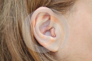 A woman with a hearing aid close-up