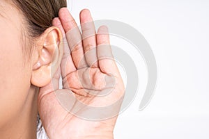 Woman hearing loss or hard of hearing and cupping her hand behind her ear isolate on white background, Deaf concept