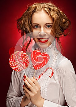 Woman with heart caramel over red background