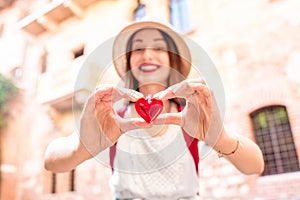 Woman with heart near Romeo and Juliet balcony