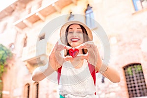 Woman with heart near Romeo and Juliet balcony