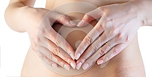 Woman heart shape hands belly