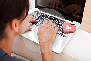 Woman with heart shape and laptop