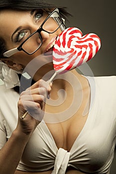 Woman with heart shaped lollipop