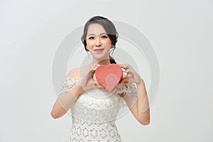 Woman with heartshape box looking camera photo