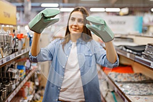 Woman in heat-resistant gloves, houseware store