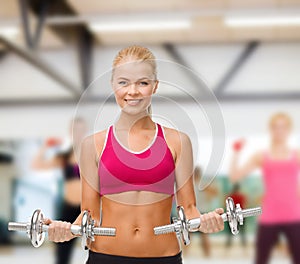 Woman with heavy steel dumbbells