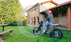 Woman with helmet riding custom motorbike