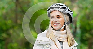 Woman, helmet and smile for park cycling with safety protection with exploring, travel or nature. Female person