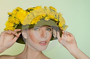 Woman in helmet with a wreath of dandelions