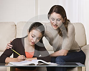 Woman Helping Daughter with Homework